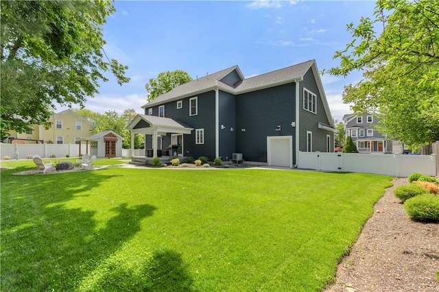 360 Pleasant St, East Providence, RI 02916 - rear view of house featuring an outdoor fire pit, a patio, a garage, and a gate
