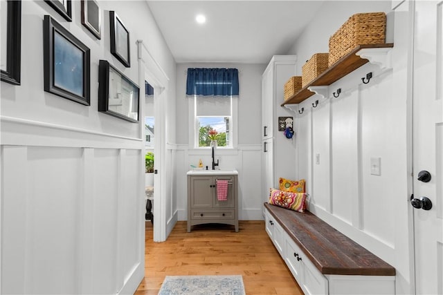 360 Pleasant St, East Providence, RI 02916 - mudroom featuring a wainscoted wall, light wood-type flooring, recessed lighting, a sink, and a decorative wall
