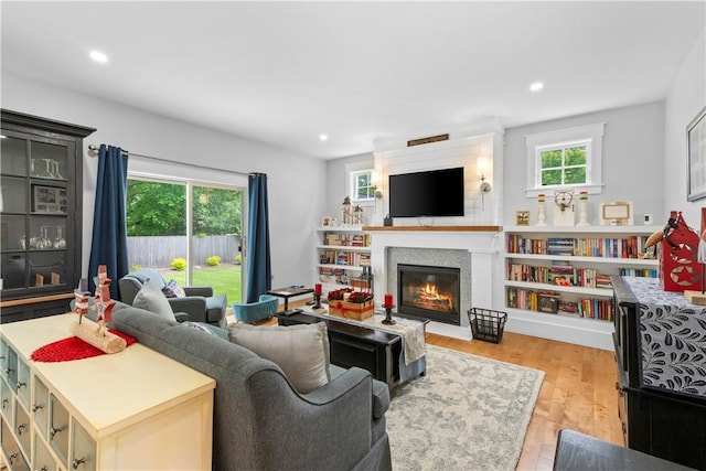 360 Pleasant St, East Providence, RI 02916 - living area featuring healthy amount of natural light, a glass covered fireplace, light wood-style floors, and recessed lighting