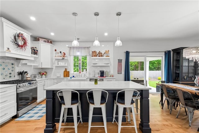 360 Pleasant St, East Providence, RI 02916 - kitchen featuring gas range, open shelves, healthy amount of natural light, a kitchen island, and recessed lighting