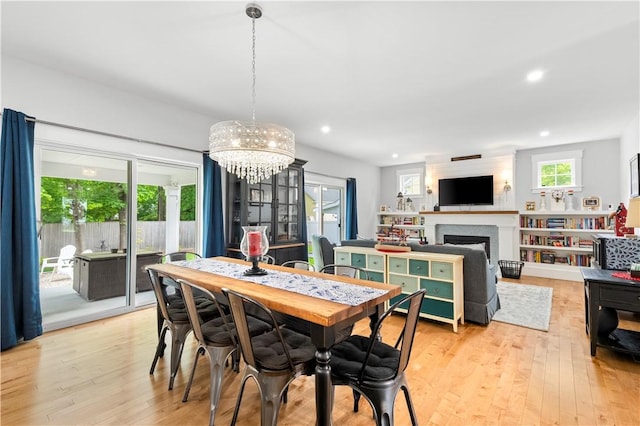 360 Pleasant St, East Providence, RI 02916 - dining area featuring a chandelier, light wood-type flooring, recessed lighting, and a fireplace