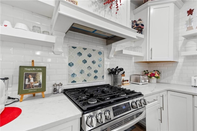 360 Pleasant St, East Providence, RI 02916 - kitchen with open shelves, gas stove, white cabinets, and tasteful backsplash