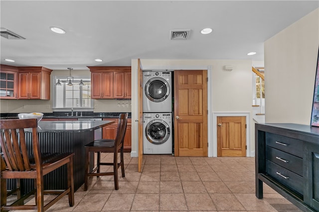 30 First School St, Bristol, RI 02809 - laundry area with estacked washer and dryer, recessed lighting, and a chandelier