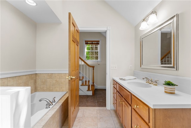 30 First School St, Bristol, RI 02809 - bathroom featuring vanity, a garden tub, vaulted ceiling, and tile patterned flooring