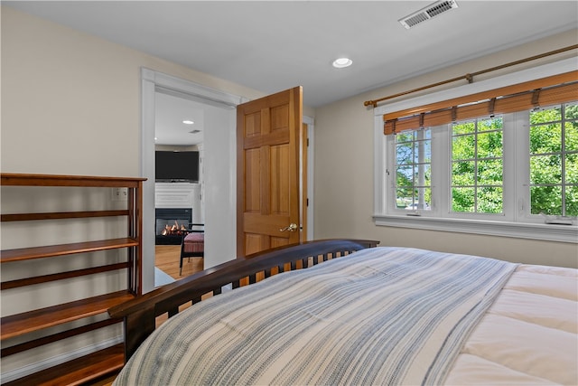 30 First School St, Bristol, RI 02809 - bedroom with multiple windows, a glass covered fireplace, and recessed lighting