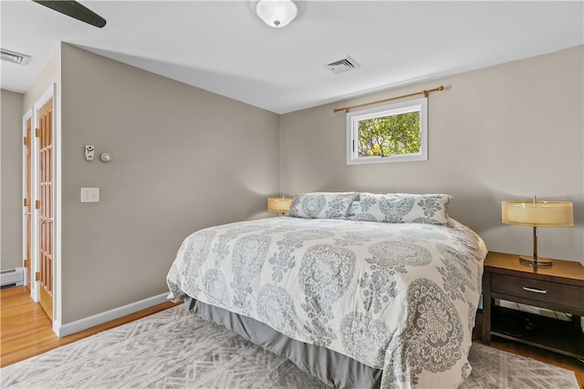 30 First School St, Bristol, RI 02809 - bedroom featuring wood finished floors, baseboard heating, and baseboards