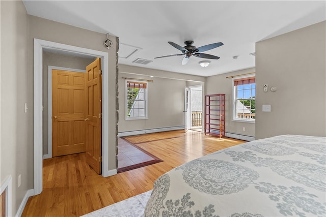 30 First School St, Bristol, RI 02809 - bedroom featuring baseboard heating, light wood-style floors, baseboards, and attic access