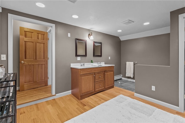 30 First School St, Bristol, RI 02809 - full bath featuring double vanity, a baseboard radiator, wood finished floors, baseboards, and recessed lighting
