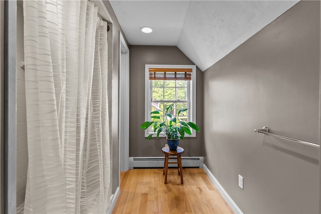 30 First School St, Bristol, RI 02809 - hall featuring a baseboard radiator, light wood-type flooring, lofted ceiling, and baseboards
