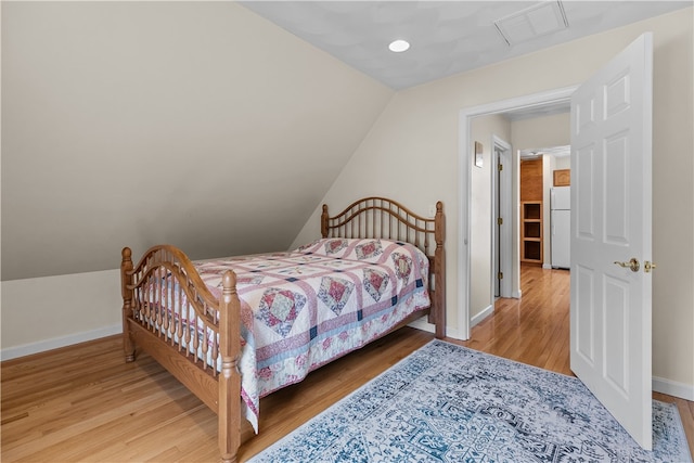 30 First School St, Bristol, RI 02809 - bedroom with freestanding refrigerator, wood finished floors, baseboards, and vaulted ceiling