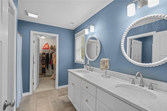 4 Overlook Cir, Coventry, RI 02816 - full bathroom with double vanity, curtained shower, baseboards, a walk in closet, and tile patterned floors