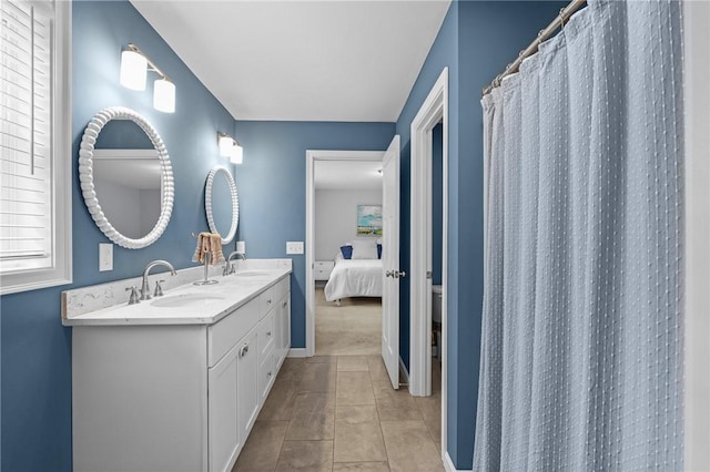 4 Overlook Cir, Coventry, RI 02816 - ensuite bathroom featuring double vanity, baseboards, and toilet