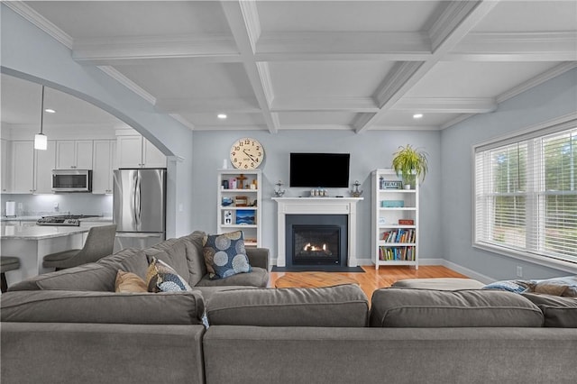 4 Overlook Cir, Coventry, RI 02816 - living area with light wood-style floors, beamed ceiling, baseboards, coffered ceiling, and arched walkways