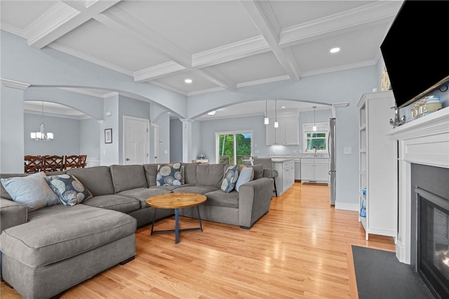 4 Overlook Cir, Coventry, RI 02816 - living area with arched walkways, a fireplace with flush hearth, recessed lighting, light wood finished floors, and beamed ceiling