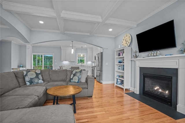 4 Overlook Cir, Coventry, RI 02816 - living room with arched walkways, light wood finished floors, recessed lighting, a fireplace with flush hearth, and crown molding