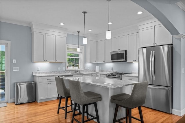 4 Overlook Cir, Coventry, RI 02816 - kitchen featuring appliances with stainless steel finishes, a breakfast bar, light wood-type flooring, recessed lighting, and a kitchen island
