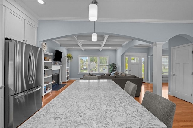 4 Overlook Cir, Coventry, RI 02816 - kitchen with freestanding refrigerator, arched walkways, open floor plan, recessed lighting, and white cabinets