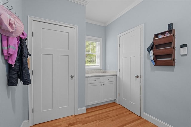 4 Overlook Cir, Coventry, RI 02816 - doorway featuring light wood-style floors, crown molding, and baseboards