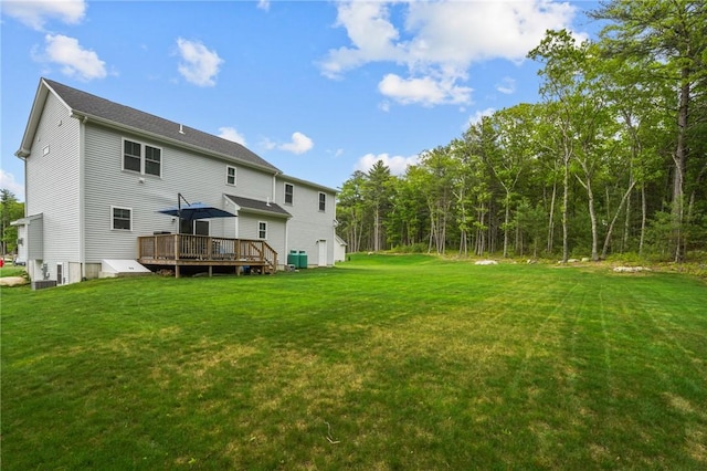 4 Overlook Cir, Coventry, RI 02816 - back of house with a deck, a lawn, and central AC