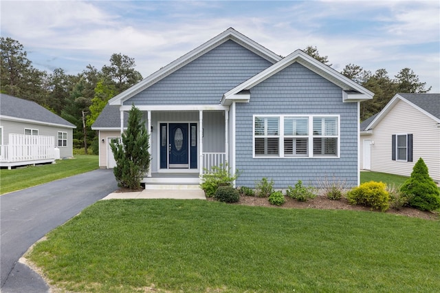 109 Chickadee Ln Unit A24, South Kingstown, RI 02879 - view of front of home featuring a front yard, asphalt driveway, a garage, and covered porch