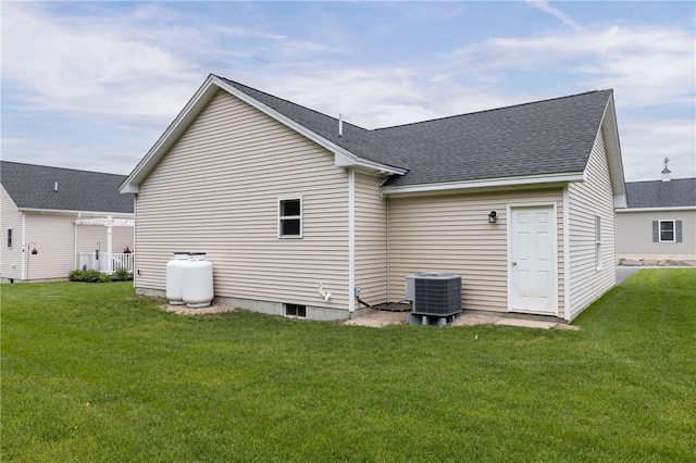 109 Chickadee Ln Unit A24, South Kingstown, RI 02879 - rear view of property with central air condition unit, a lawn, and roof with shingles