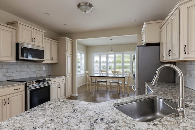 109 Chickadee Ln Unit A24, South Kingstown, RI 02879 - kitchen with appliances with stainless steel finishes, a sink, light stone countertops, wood finished floors, and recessed lighting