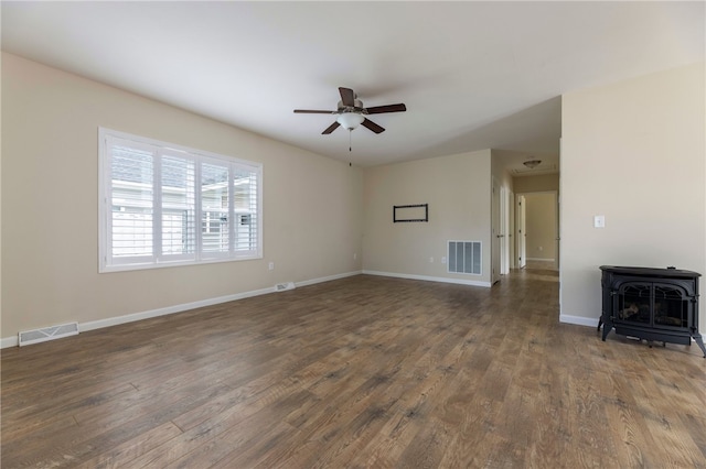 109 Chickadee Ln Unit A24, South Kingstown, RI 02879 - unfurnished living room featuring a wood stove, a ceiling fan, wood finished floors, and baseboards