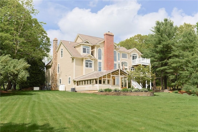 51 Reservoir Rd, Cumberland, RI 02864 - rear view of house featuring a yard, a sunroom, and a chimney