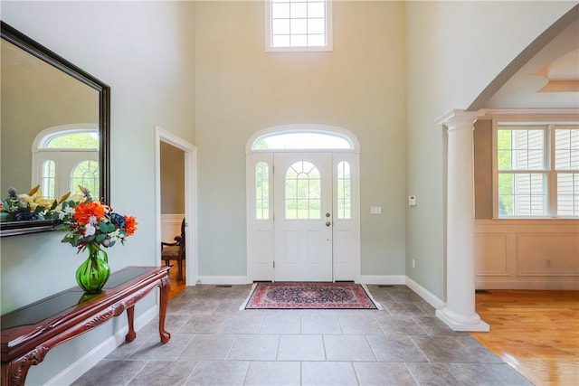 51 Reservoir Rd, Cumberland, RI 02864 - foyer entrance featuring ornate columns, a high ceiling, healthy amount of natural light, and baseboards