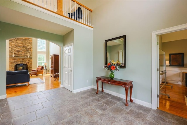 51 Reservoir Rd, Cumberland, RI 02864 - entrance foyer with arched walkways, a high ceiling, baseboards, and tile patterned floors