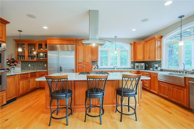 51 Reservoir Rd, Cumberland, RI 02864 - kitchen with appliances with stainless steel finishes, a sink, decorative backsplash, light wood finished floors, and recessed lighting