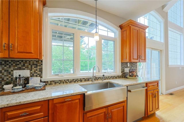 51 Reservoir Rd, Cumberland, RI 02864 - kitchen with a sink, dishwasher, decorative backsplash, light stone counters, and hanging light fixtures
