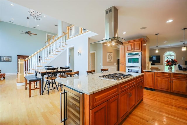 51 Reservoir Rd, Cumberland, RI 02864 - kitchen featuring wine cooler, appliances with stainless steel finishes, a ceiling fan, light wood finished floors, and island exhaust hood