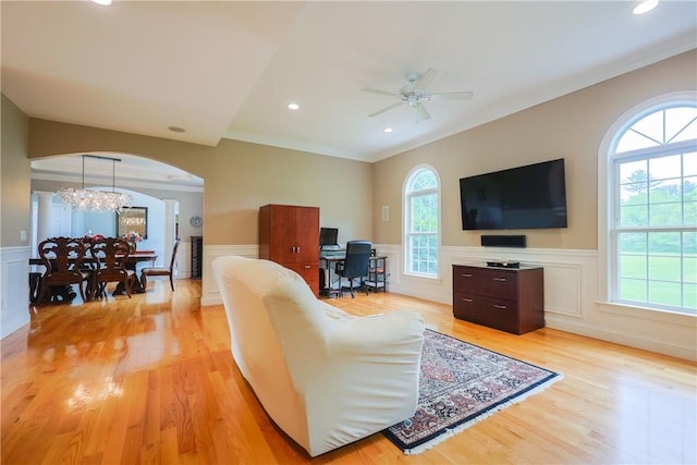 51 Reservoir Rd, Cumberland, RI 02864 - living room with plenty of natural light, crown molding, arched walkways, light wood-style flooring, and ceiling fan