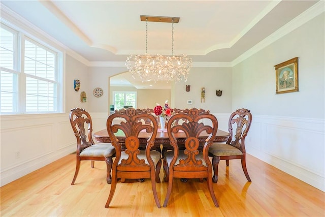 51 Reservoir Rd, Cumberland, RI 02864 - dining space featuring a raised ceiling, light wood-type flooring, wainscoting, a chandelier, and a decorative wall