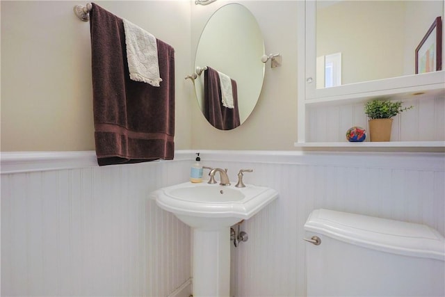 51 Reservoir Rd, Cumberland, RI 02864 - bathroom with a wainscoted wall, toilet, and a sink