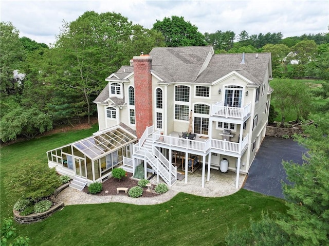 51 Reservoir Rd, Cumberland, RI 02864 - rear view of house with roof with shingles, a chimney, a yard, stairway, and a wooden deck