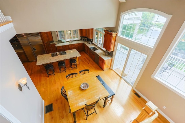 51 Reservoir Rd, Cumberland, RI 02864 - dining space featuring light wood-type flooring, baseboards, and a high ceiling