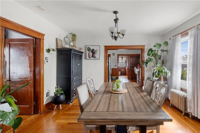 93 Pleasant St, Cranston, RI 02910 - dining space with light wood finished floors, radiator, and a chandelier