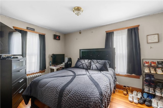 93 Pleasant St, Cranston, RI 02910 - bedroom featuring multiple windows, wood finished floors, and radiator