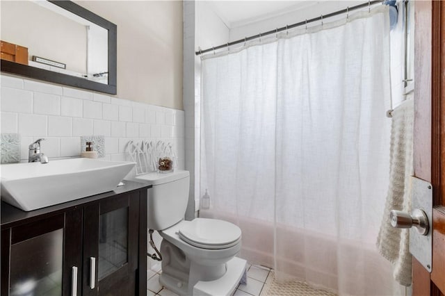 93 Pleasant St, Cranston, RI 02910 - bathroom featuring vanity, shower / bath combo with shower curtain, tile patterned flooring, toilet, and tile walls