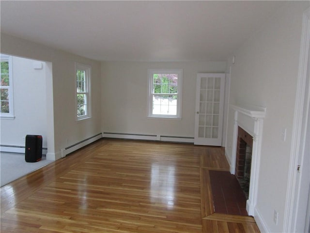 524 Middle Rd, East Greenwich, RI 02818 - unfurnished living room featuring plenty of natural light, wood finished floors, a baseboard heating unit, and a fireplace