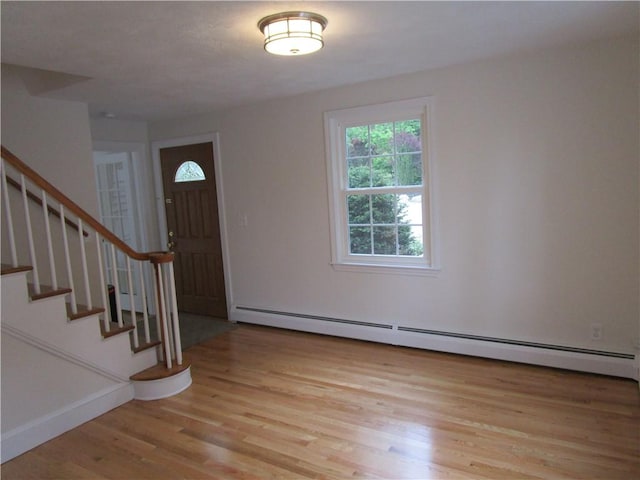 524 Middle Rd, East Greenwich, RI 02818 - foyer with a baseboard radiator, light wood-style flooring, stairway, and baseboards