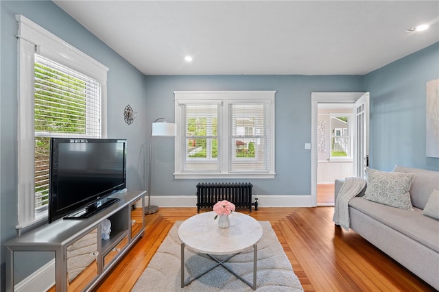 39 Sampson Ave, North Providence, RI 02911 - living room with radiator heating unit, healthy amount of natural light, light wood-style flooring, baseboards, and recessed lighting