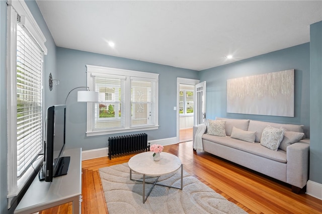 39 Sampson Ave, North Providence, RI 02911 - living room with radiator heating unit, wood finished floors, baseboards, and recessed lighting