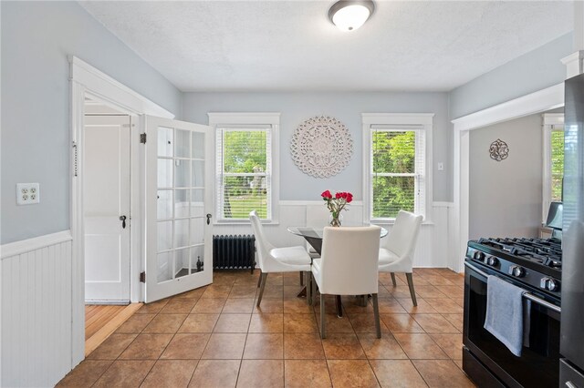 39 Sampson Ave, North Providence, RI 02911 - dining room featuring radiator, wainscoting, and tile patterned flooring