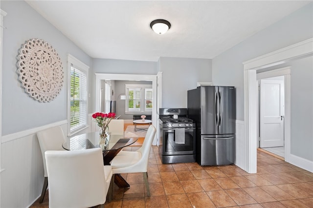 39 Sampson Ave, North Providence, RI 02911 - kitchen with stainless steel appliances, wainscoting, and light tile patterned flooring