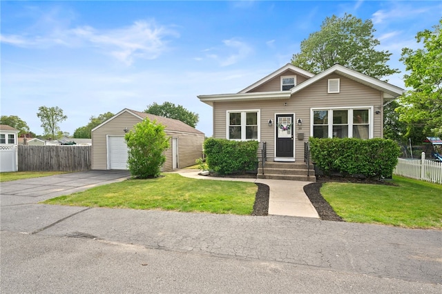 39 Sampson Ave, North Providence, RI 02911 - view of front of home with an outdoor structure, driveway, and a garage