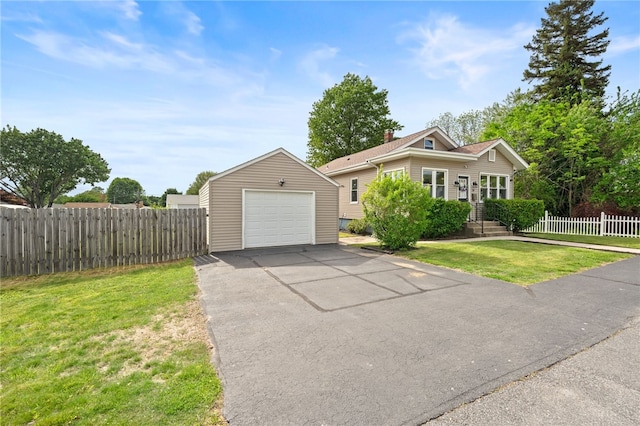 39 Sampson Ave, North Providence, RI 02911 - view of front facade with a garage, an outdoor structure, and asphalt driveway