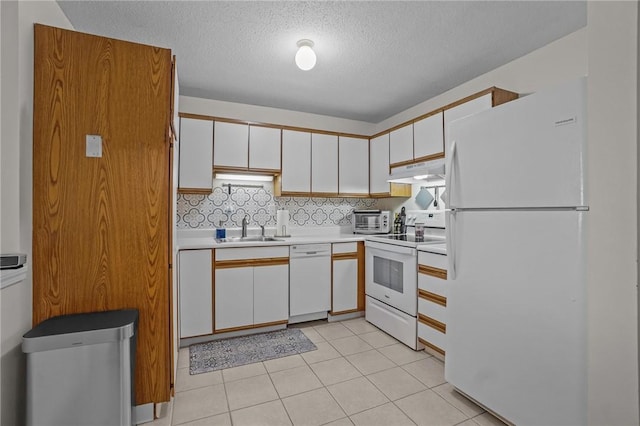 724 Beverage Hill Ave Unit 304, Pawtucket, RI 02861 - kitchen with white appliances, under cabinet range hood, a sink, white cabinetry, and a textured ceiling